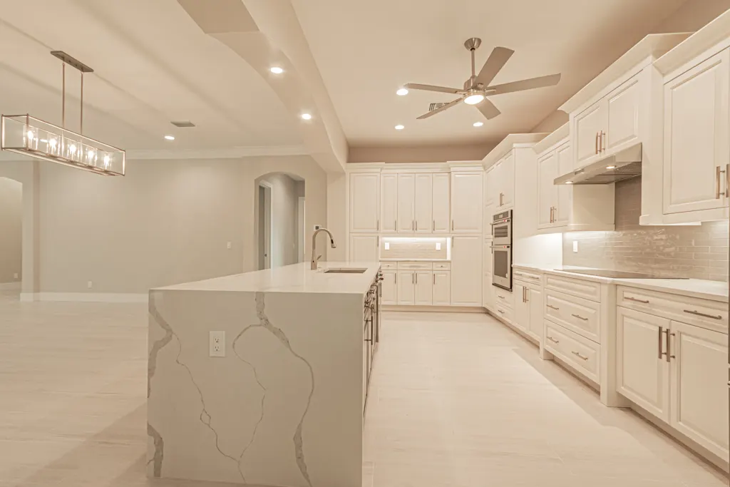 Kitchen wide view at The Heron House, a custom home built by Marvin Homes in Naples, Florida