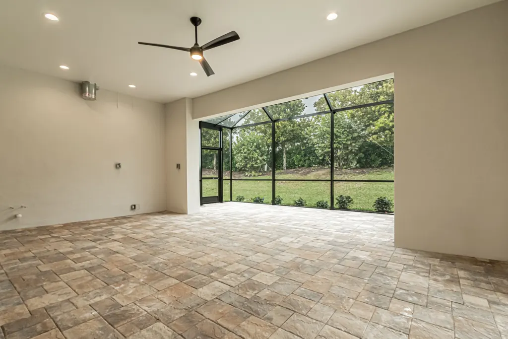 Screened porch interior at The Heron House, a custom home built by Marvin Homes in Naples, Florida