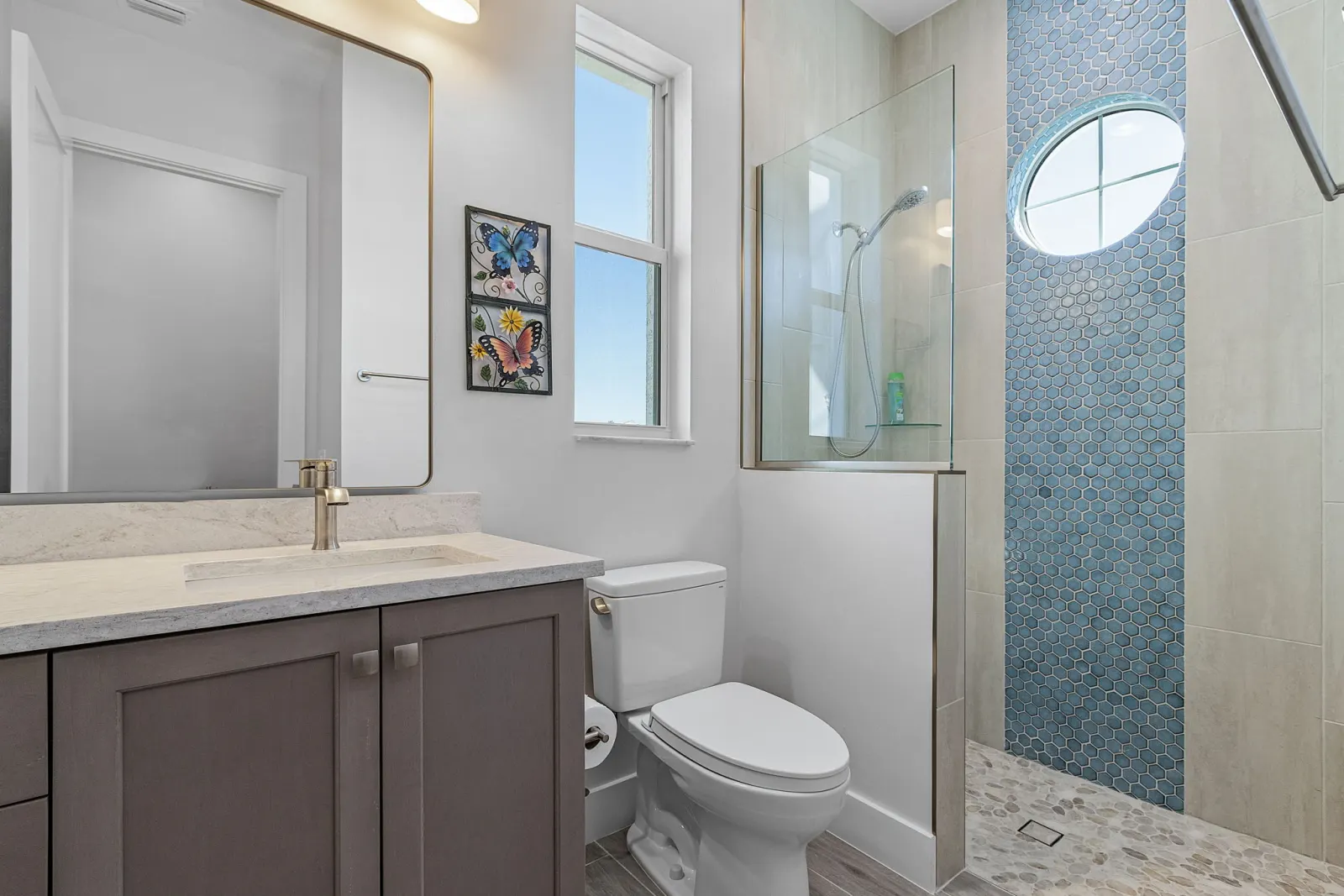 Bathroom shower blue hex tile at The Marlin, a custom home built by Marvin Homes in Cape Coral, Florida