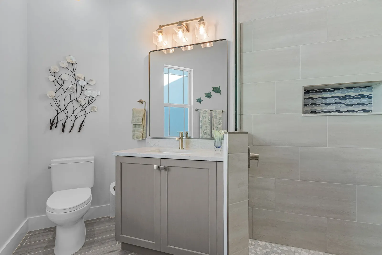 Bathroom vanity wave tile shower at The Marlin, a custom home built by Marvin Homes in Cape Coral, Florida