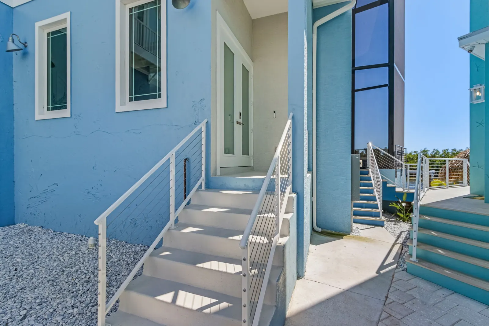 Exterior side entry stairs at The Marlin, a custom home built by Marvin Homes in Cape Coral, Florida