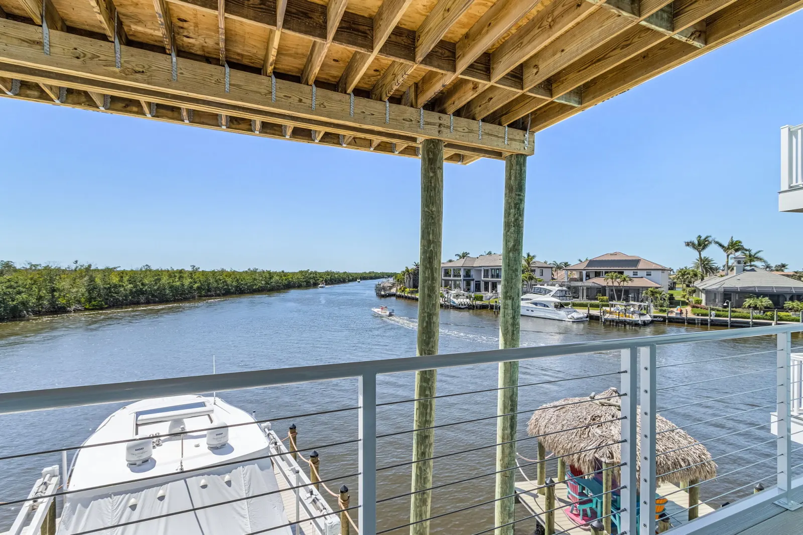 Balcony tiki hut canal view at Pelican's Perch, a custom home built by Marvin Homes in Cape Coral, Florida