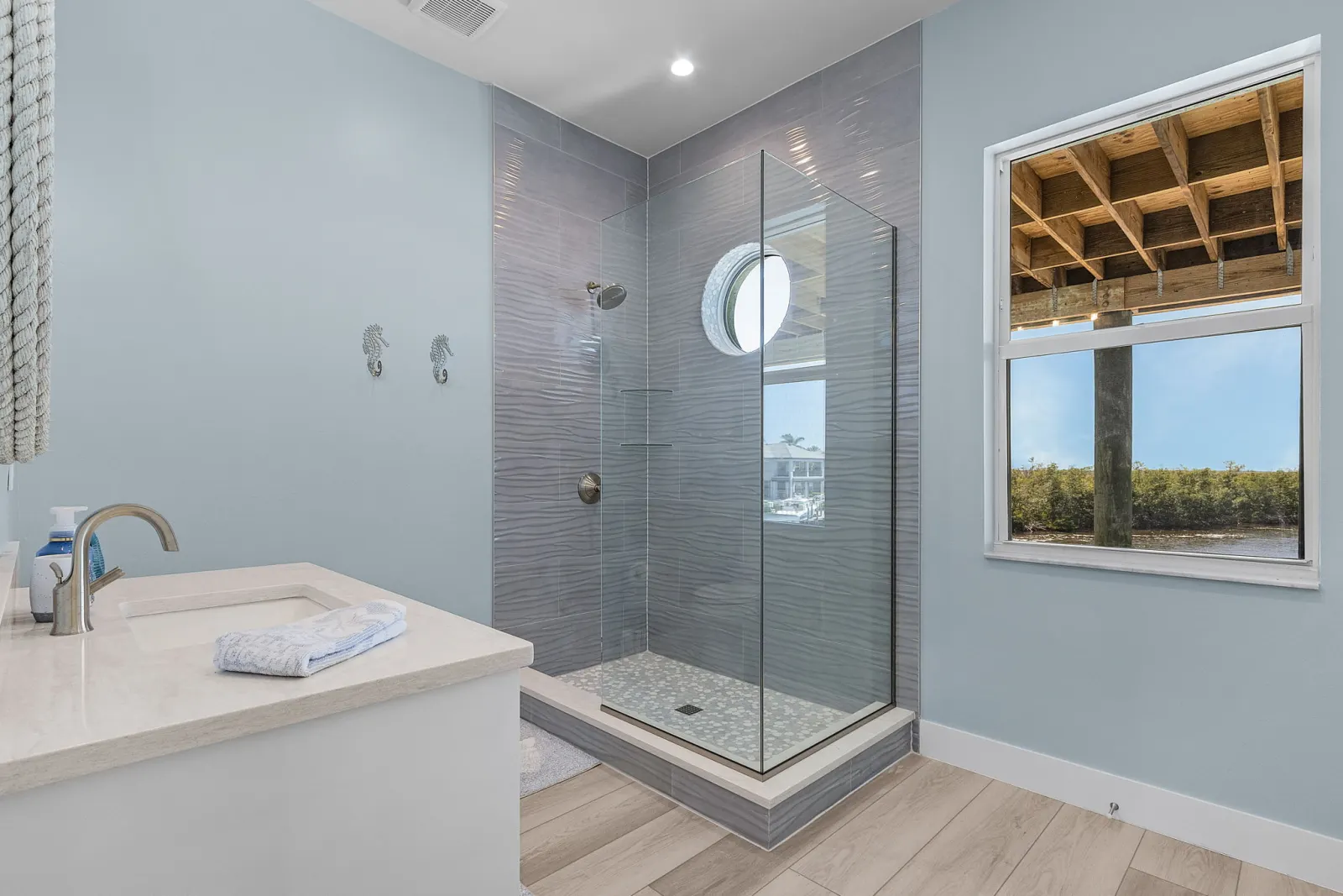 Bathroom wave tile shower detail at Pelican's Perch, a custom home built by Marvin Homes in Cape Coral, Florida