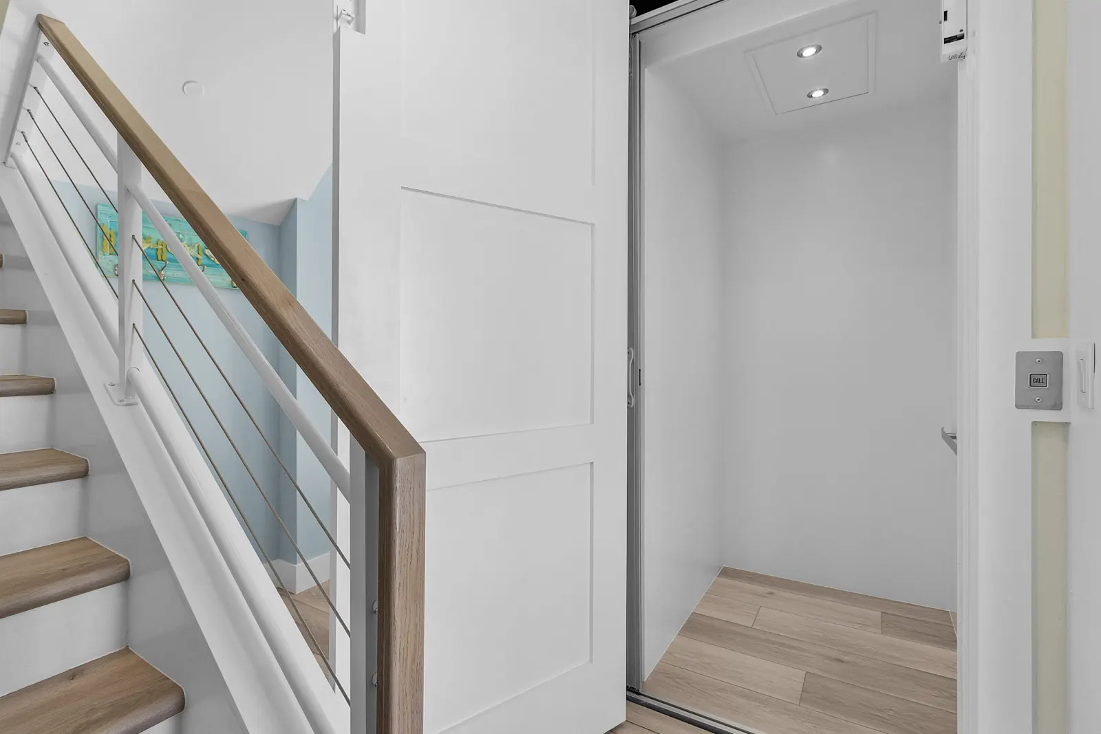 Entry elevator staircase at Pelican's Perch, a custom home built by Marvin Homes in Cape Coral, Florida