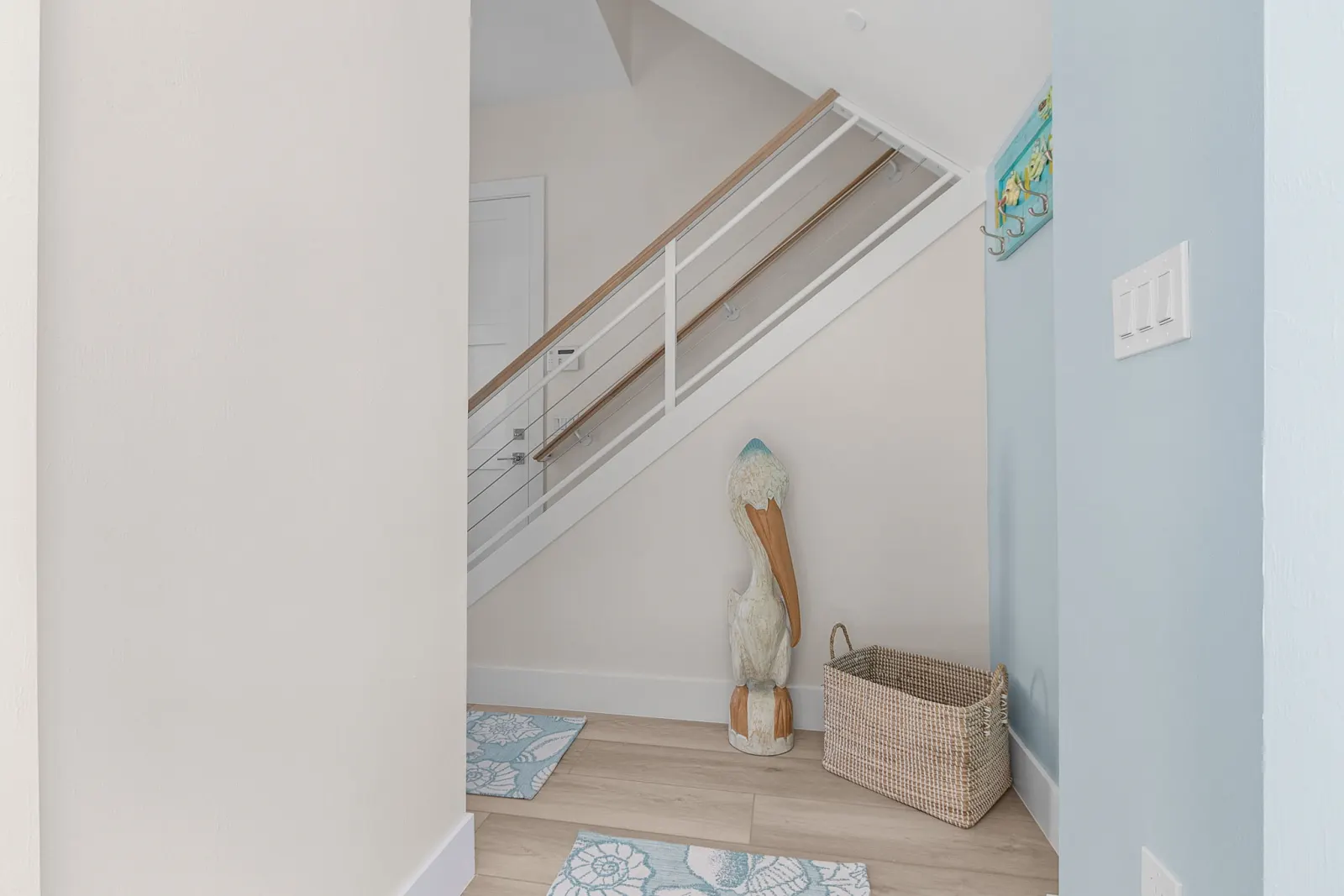 Entry under stairs pelican decor at Pelican's Perch, a custom home built by Marvin Homes in Cape Coral, Florida