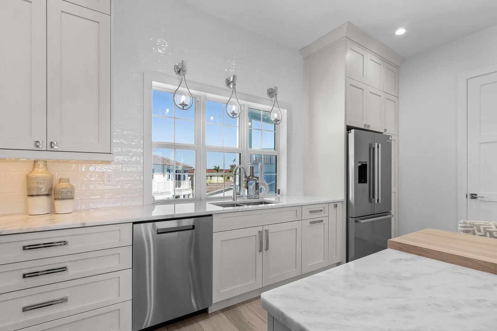 Kitchen sink window fridge at Pelican's Perch, a custom home built by Marvin Homes in Cape Coral, Florida
