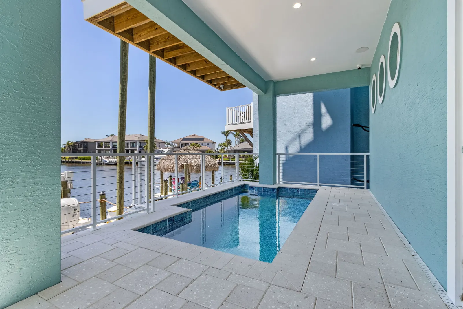 Pool deck canal view at Pelican's Perch, a custom home built by Marvin Homes in Cape Coral, Florida